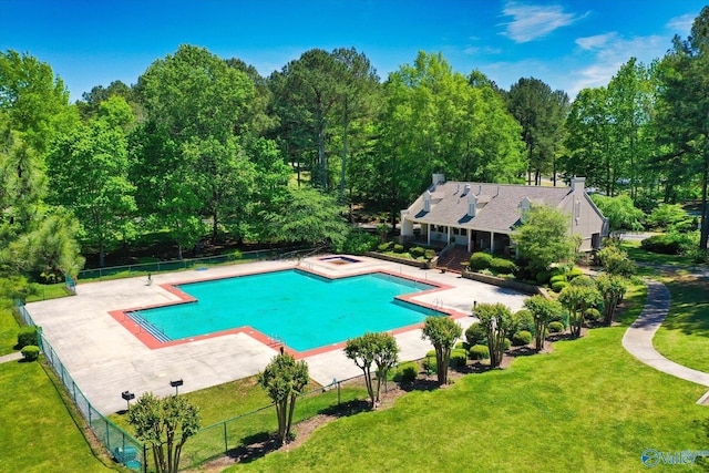 view of swimming pool with a patio area and a yard