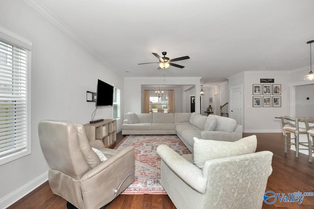 living room featuring dark wood-style floors, baseboards, and ornamental molding