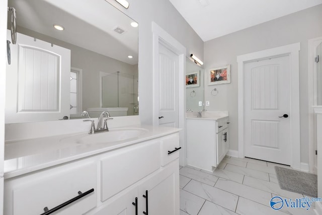 full bathroom with recessed lighting, two vanities, a sink, marble finish floor, and a stall shower