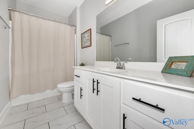 bathroom with marble finish floor, shower / tub combo with curtain, vanity, and toilet