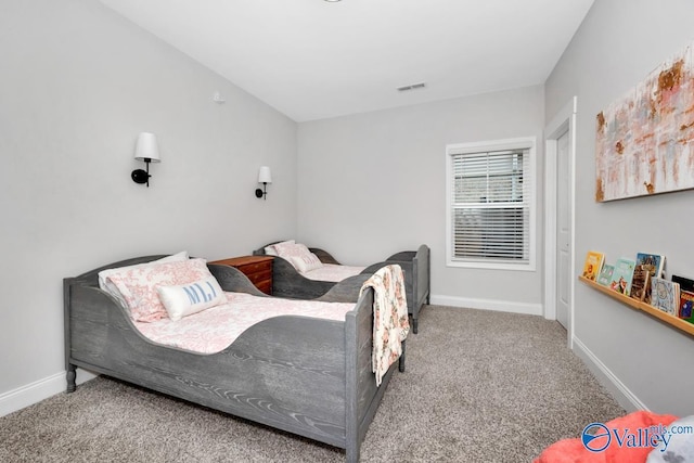 carpeted bedroom with baseboards and visible vents