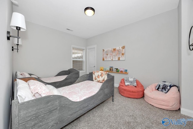 bedroom featuring carpet floors, visible vents, and baseboards