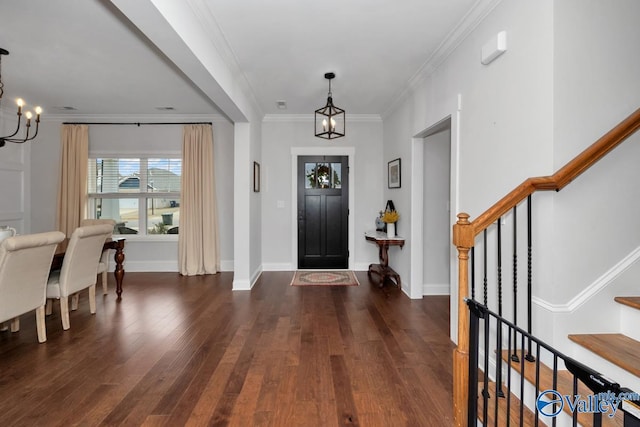 foyer featuring baseboards, stairway, dark wood-type flooring, crown molding, and a chandelier