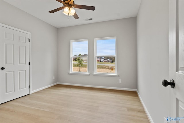 empty room with light hardwood / wood-style flooring and ceiling fan