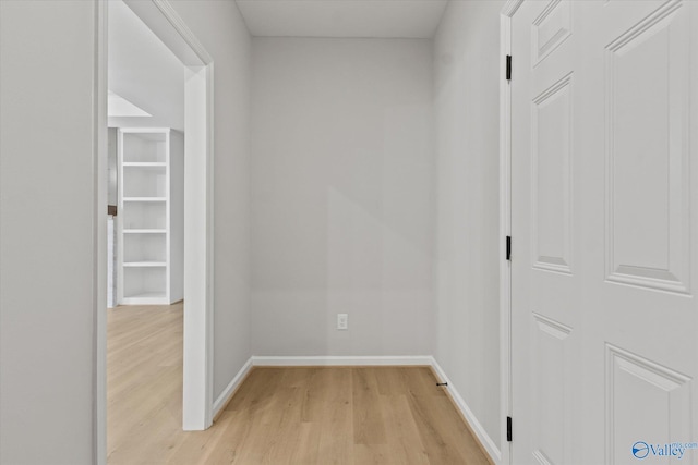 corridor with light hardwood / wood-style floors