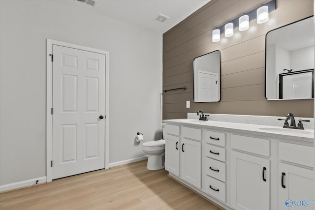 bathroom with vanity, hardwood / wood-style flooring, and toilet