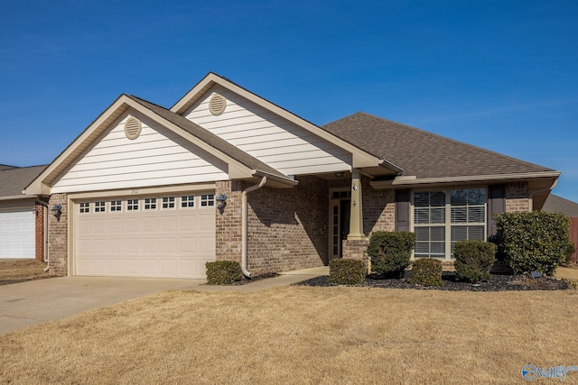 view of front of property with a garage and a front lawn