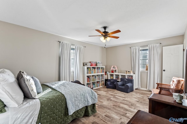 bedroom with ceiling fan and light wood-type flooring