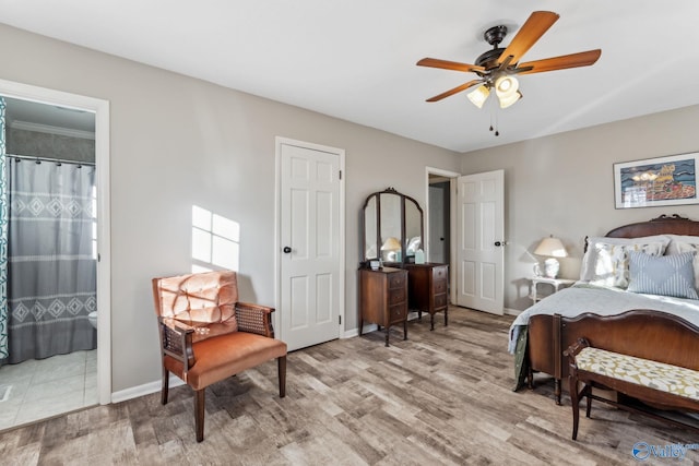 bedroom featuring ensuite bathroom, ceiling fan, and light wood-type flooring