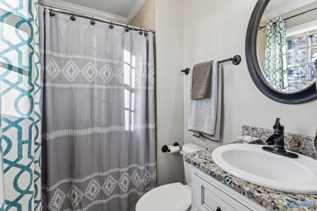 bathroom with toilet, vanity, a shower with shower curtain, and ornamental molding