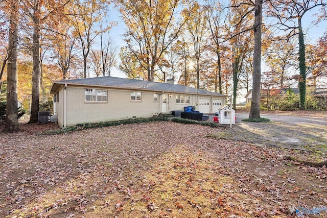 exterior space with a garage and central AC unit