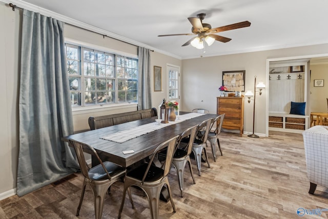 dining room featuring ceiling fan, light wood-type flooring, and ornamental molding