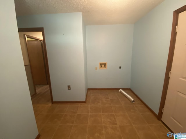 laundry room with electric dryer hookup, hookup for a washing machine, and a textured ceiling