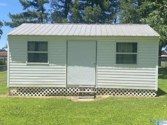 view of outbuilding featuring a yard