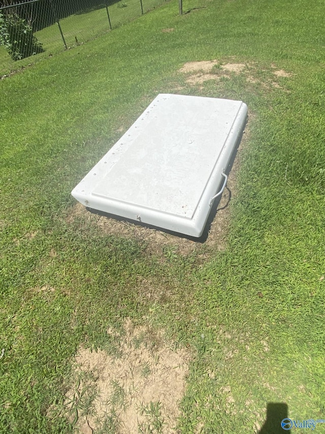 view of storm shelter featuring a yard