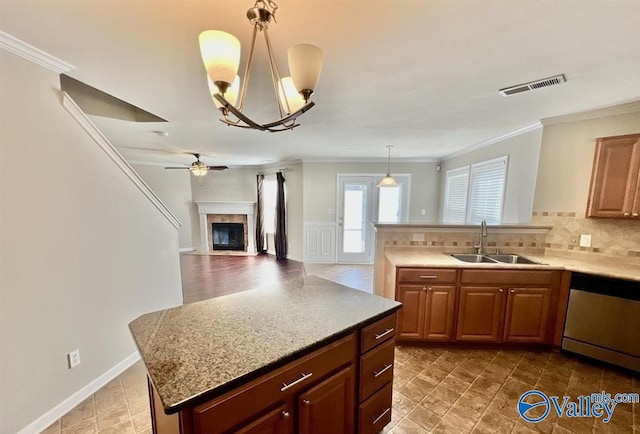 kitchen with pendant lighting, ornamental molding, dishwasher, and sink