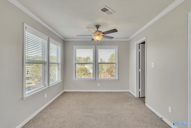 carpeted spare room with crown molding, ceiling fan, and plenty of natural light