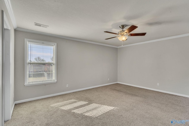 carpeted empty room with a textured ceiling, ornamental molding, and ceiling fan