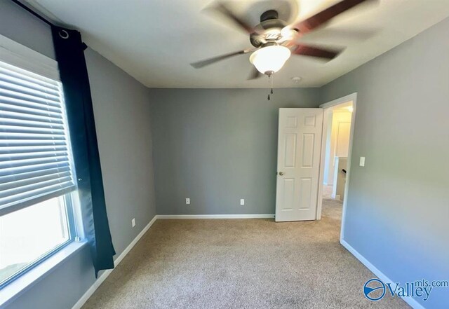 unfurnished bedroom with light colored carpet and ceiling fan