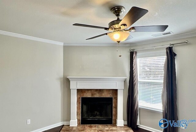 unfurnished living room with ceiling fan, ornamental molding, and a fireplace