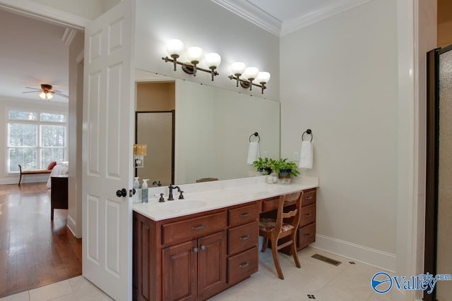 bathroom featuring ornamental molding, hardwood / wood-style flooring, vanity, and ceiling fan