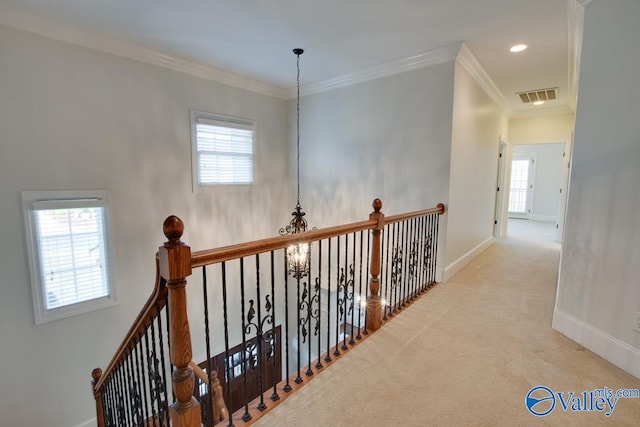 hallway with light carpet and ornamental molding