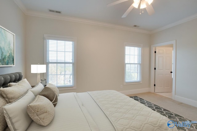 carpeted bedroom featuring ceiling fan and crown molding