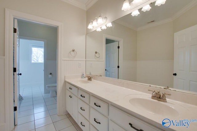 bathroom featuring toilet, vanity, tile patterned floors, and crown molding