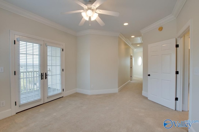 carpeted empty room featuring ceiling fan, french doors, and ornamental molding