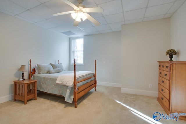 bedroom featuring a paneled ceiling, light colored carpet, and ceiling fan