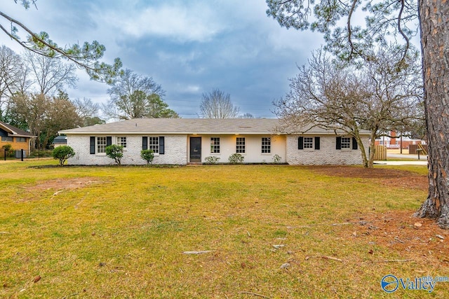 single story home featuring brick siding and a front yard