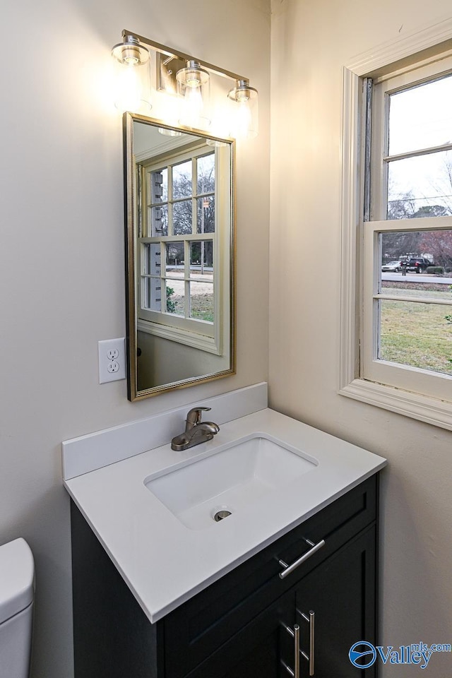 half bath featuring toilet and vanity