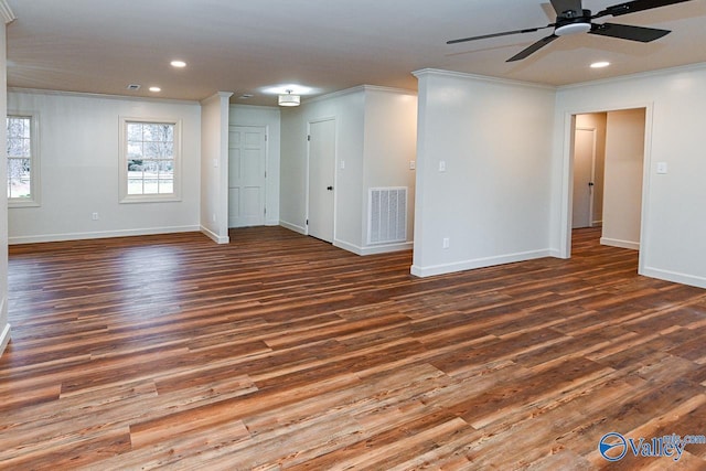 spare room featuring ornamental molding, wood finished floors, and visible vents