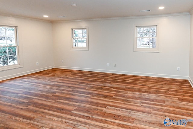 spare room featuring ornamental molding, recessed lighting, visible vents, and wood finished floors