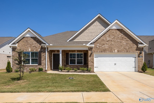 craftsman-style house featuring a garage and a front lawn