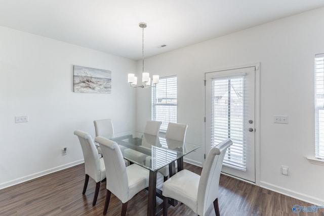 dining room with a notable chandelier and dark hardwood / wood-style flooring