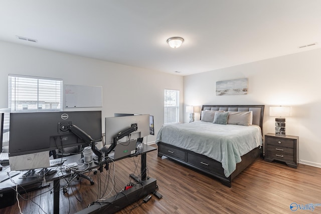 bedroom featuring hardwood / wood-style floors and multiple windows