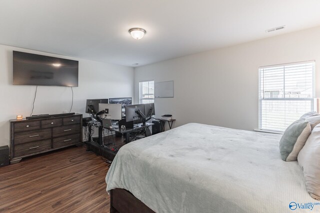 bedroom with dark wood-type flooring