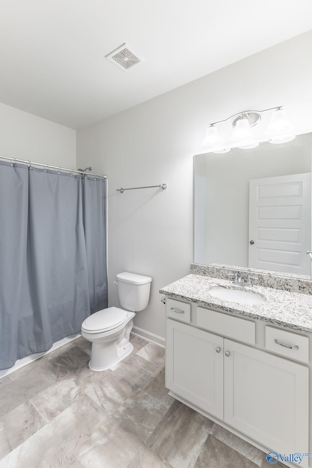 bathroom featuring walk in shower, vanity, and toilet