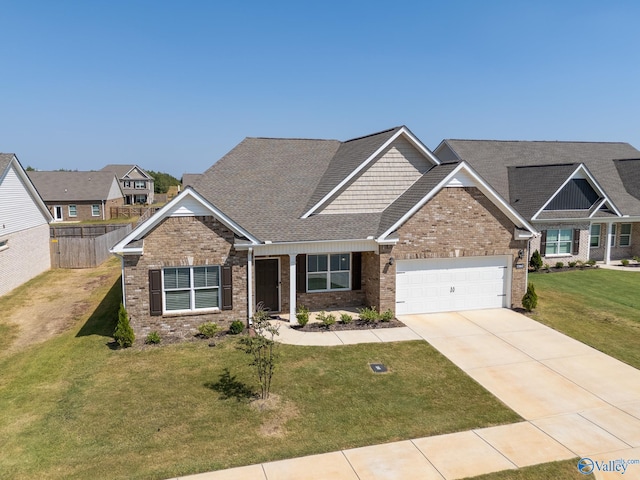 craftsman-style house featuring a garage and a front lawn