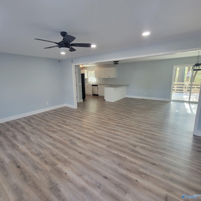 unfurnished living room with light hardwood / wood-style flooring and ceiling fan