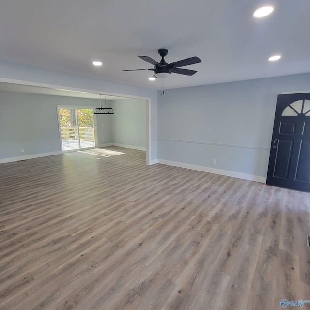 unfurnished living room featuring light wood-type flooring and ceiling fan