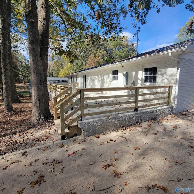 view of side of home featuring a wooden deck