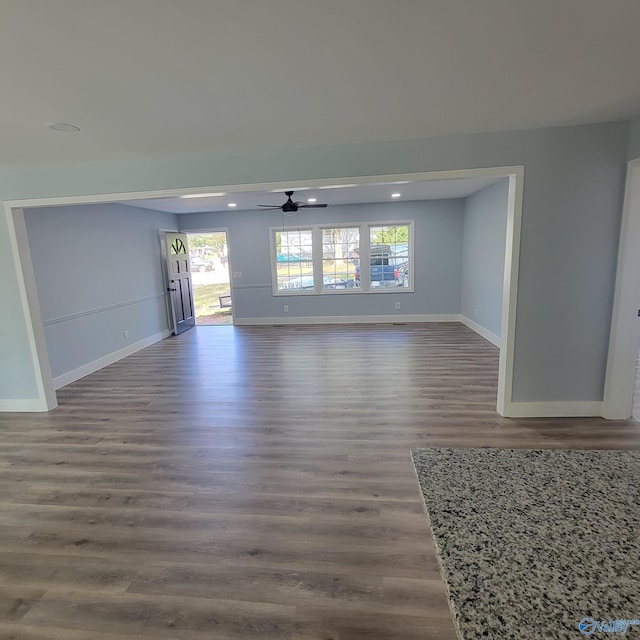 unfurnished room with ceiling fan and dark hardwood / wood-style flooring