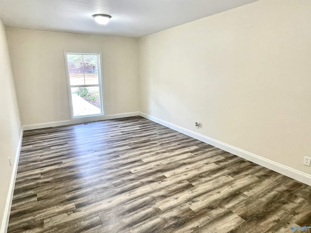 empty room with dark hardwood / wood-style floors