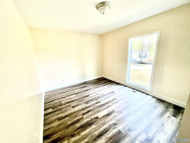 spare room featuring dark hardwood / wood-style flooring