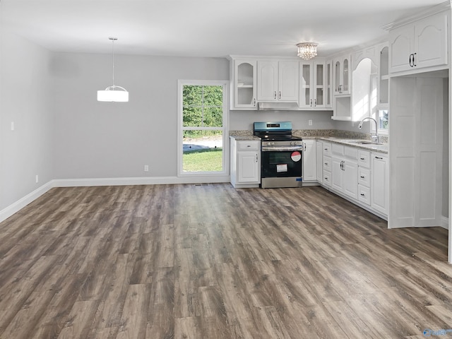 kitchen featuring electric stove, sink, white cabinetry, and light stone countertops