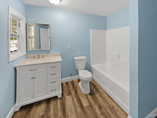 full bathroom with vanity, shower / bathing tub combination, wood-type flooring, and toilet