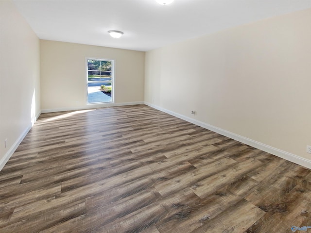 empty room with dark hardwood / wood-style floors