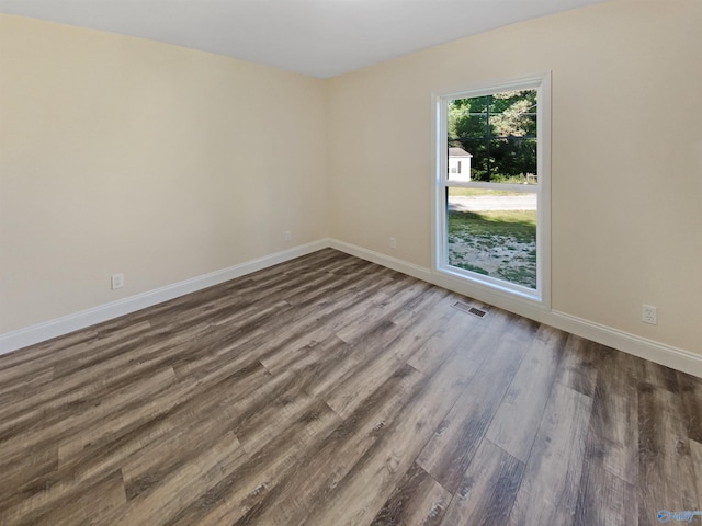 spare room featuring dark hardwood / wood-style flooring